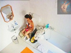 A magnificent brunette takes a piss in a bathroom porno video