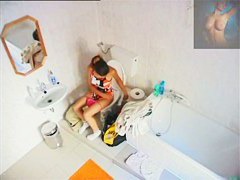 A magnificent brunette takes a piss in a bathroom porno video