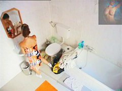 A magnificent brunette takes a piss in a bathroom porno video