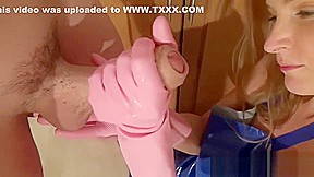 Amazing girl gives pink rubber glove handjob
