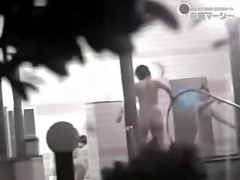 Asian woman pouring nude body with water before the pool