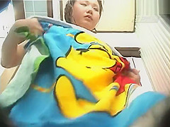 Asian woman showering in shower cabin