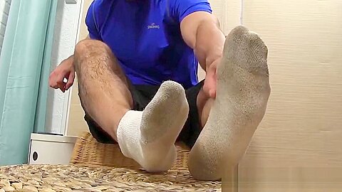 Attractive hunk plays around with feet and massages them