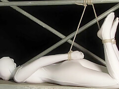 Babe Wrapped In White Zentai Suit Enjoys To Be Bondaged To A Metal Pole