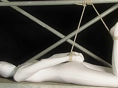Babe Wrapped In White Zentai Suit Enjoys To Be Bondaged To A Metal Pole