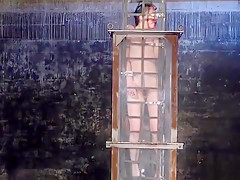 Babe in cage gets water bondage
