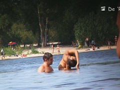 Beach nudist couple having sex in water on cam