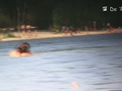 Beach nudist couple having sex in water on cam