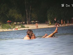 Beach nudist couple having sex in water on cam