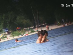 Beach nudist couple having sex in water on cam
