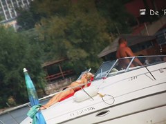 Beach nudist couple having sex in water on cam