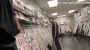 Bearded white man sucking and fucking a black cock at a gloryhole