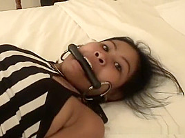 Beautiful Asian handcuffed on the bed