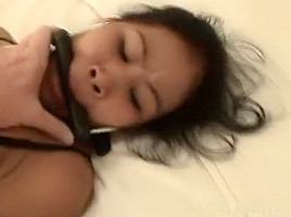 Beautiful Asian handcuffed on the bed