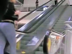 Big booty in blue jeans in a shopping mall candid video