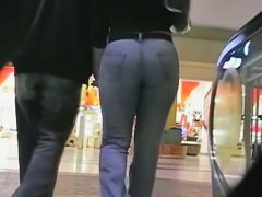 Big booty in blue jeans in a shopping mall candid video