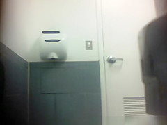 Blonde in jeans pants peeing in toilet