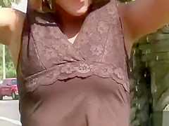 Blonde nympho takes out her titties in a public fountain