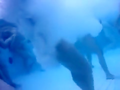 Bunch of naked people have fun in the swimming pool