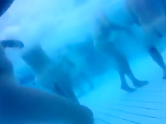 Bunch of naked people have fun in the swimming pool