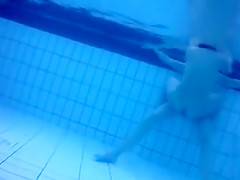 Bunch of naked people have fun in the swimming pool