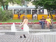 Busty slave bathing in fountain outdoor