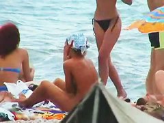 Buxom nude beach babes flaunt their jugs before a