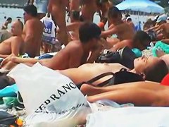 Buxom nude beach babes flaunt their jugs before a