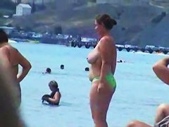 Buxom nude beach babes flaunt their jugs before a