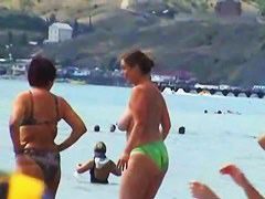 Buxom nude beach babes flaunt their jugs before a