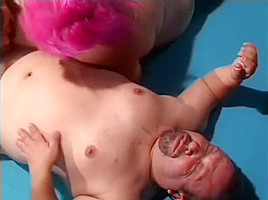 Chubby ladies play with a dildo and share a midget's cock in the ring