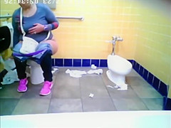 Chubby woman spied in public toilet peeing