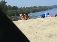 Cute lesbian teens 18+ enjoying sunbathing at nudist beach