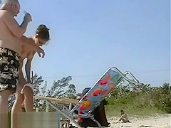Dark haired nudist spied pissing on the beachvoyeur