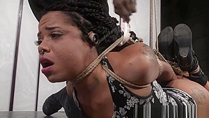 Ebony sub enjoys being hogtied and suspended