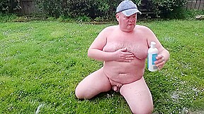 Fat man has muddy fun