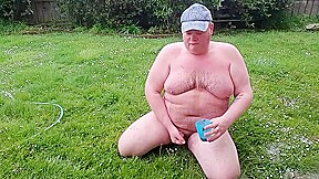 Fat man has muddy fun
