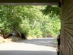 Gagged slut suspended from a bridge