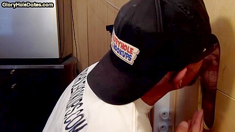 Homemade DILF sucks ands wanks penis through gloryhole