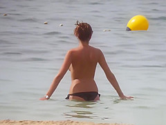 Hot body brunette with perfect tits filmed on topless beach