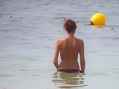 Hot body brunette with perfect tits filmed on topless beach