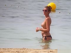Hot body brunette with perfect tits filmed on topless beach