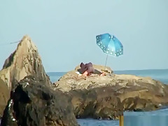 Kinky couple having naughty fun on a nice secluded beach