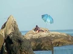 Kinky couple having naughty fun on a nice secluded beach
