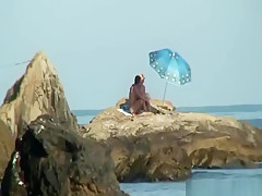 Kinky couple having naughty fun on a nice secluded beach