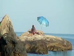 Kinky couple having naughty fun on a nice secluded beach