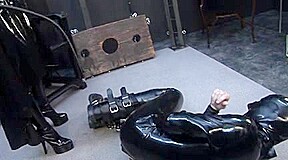 Latex male slut sucks big dildo in spandex porn video