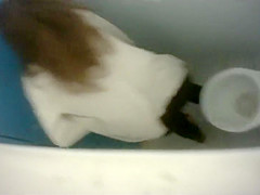 Long-haired brunette with a bubble butt takes a quick pee in the college restroom