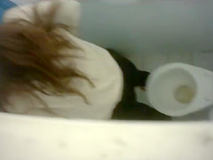Long-haired brunette with a bubble butt takes a quick pee in the college restroom