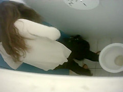 Long-haired brunette with a bubble butt takes a quick pee in the college restroom
